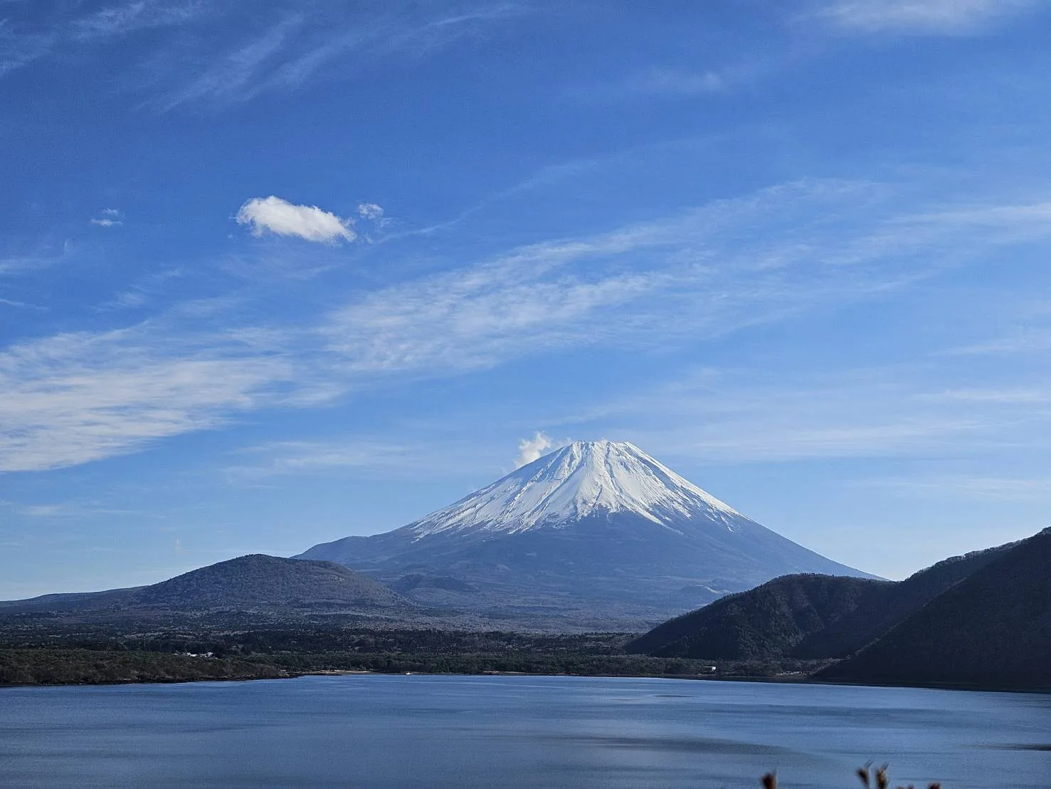 Snow-capped Mt. Fuji over a lake